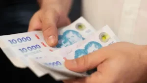 Billetes y una calculadora sobre una mesa, simbolizando inversiones y plazos fijos